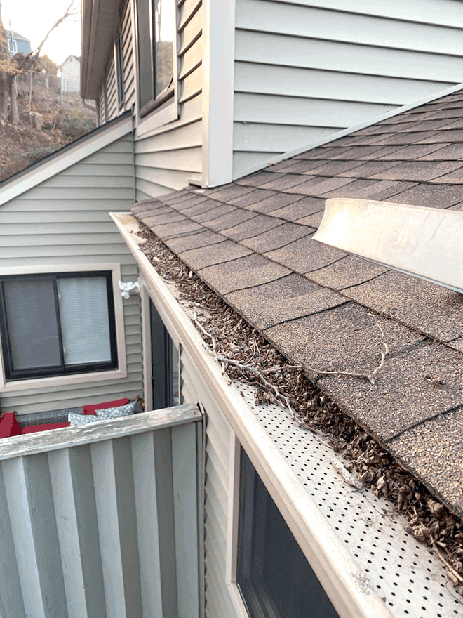 Seasonal cleanup of debris on top of gutter guards in Connecticut